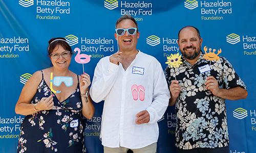Ice-cream social attendants posing with fun props