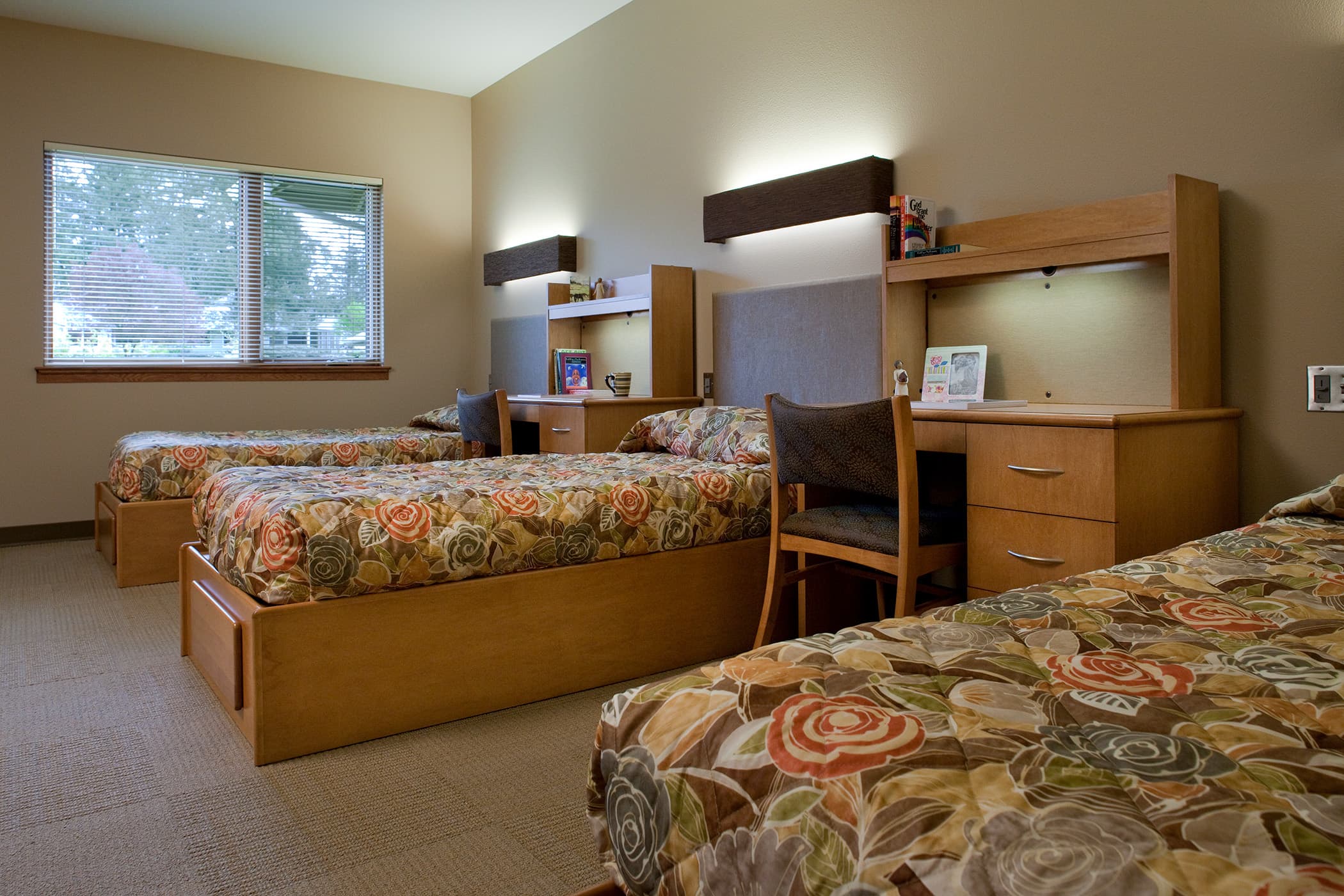 bedroom with two beds and a desk