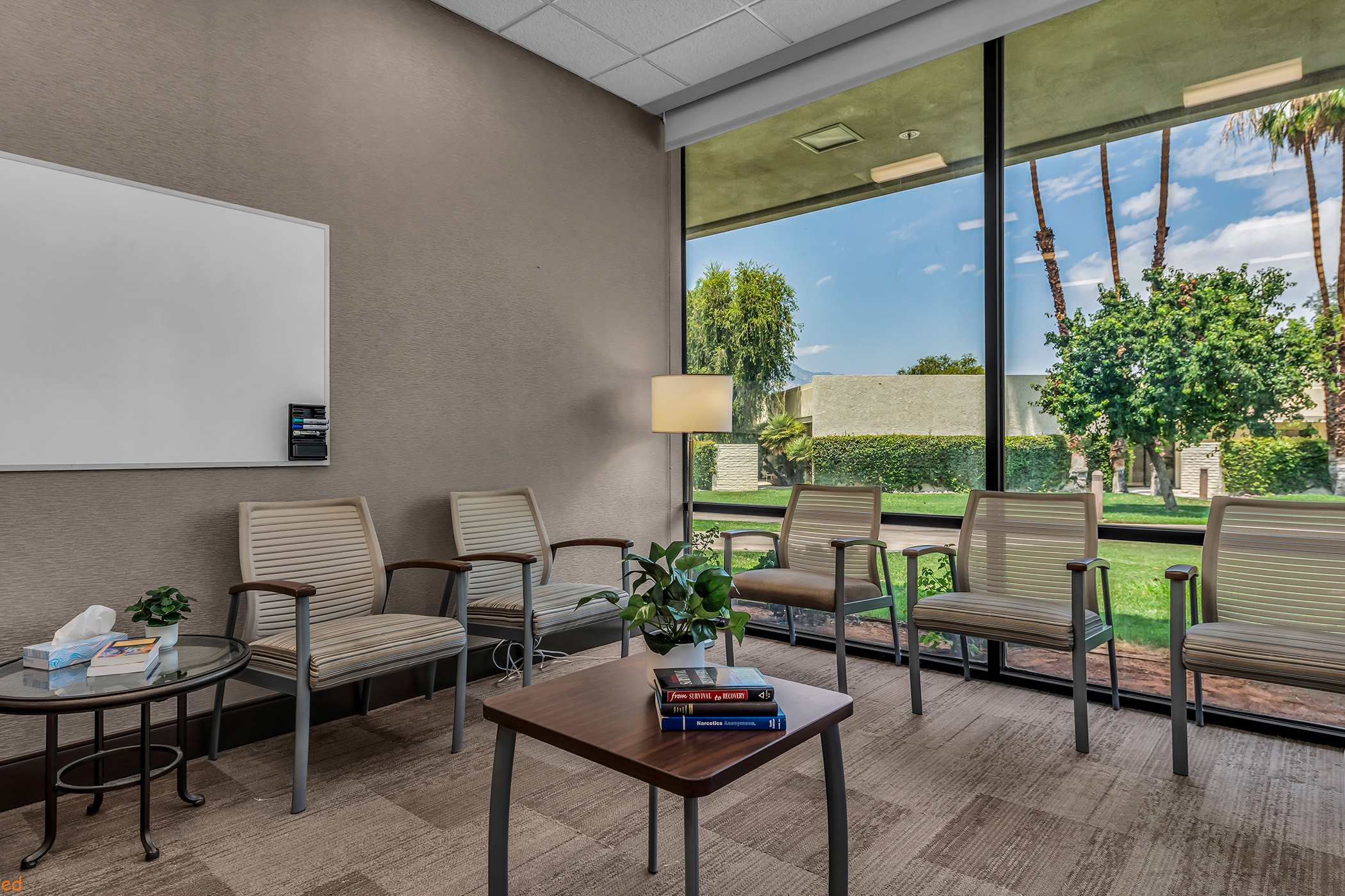 Inside a meeting room with chairs and a large window