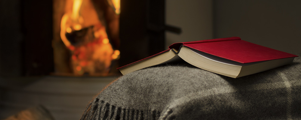 Open Book on blanket by fireplace